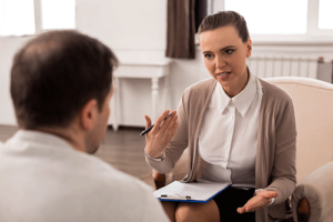a therapist talks to a person in a depression treatment program