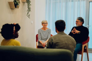 a group in a partial hospitalization program listens to a therapist