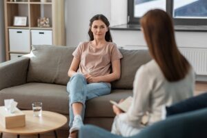 a client listens while a therapist answers "what is CBT?"